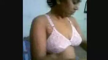 Uncovering Desi Beauty: Watch Busty Indian Girl Poorna Change Into a Pink Bra in Her Bedroom!