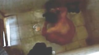 Indian Desi home nurse taking bath captured using hidden webcam placed on roof .