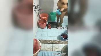 Desi chubby pours water all over her naked body, teasing the fuckin' hidden cam