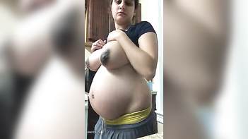 Busty Pregnant Desi Slut Raises Shirt, Flaunts XXX Coconuts in Wild Action.
