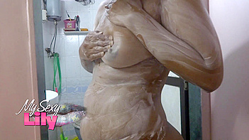 Lily rubs those juicy tits in the bathroom, seducing the fuck out of her fans